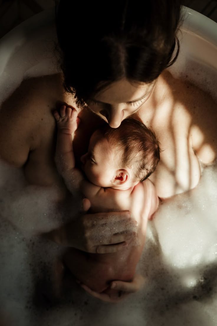 mom and baby in bath tub