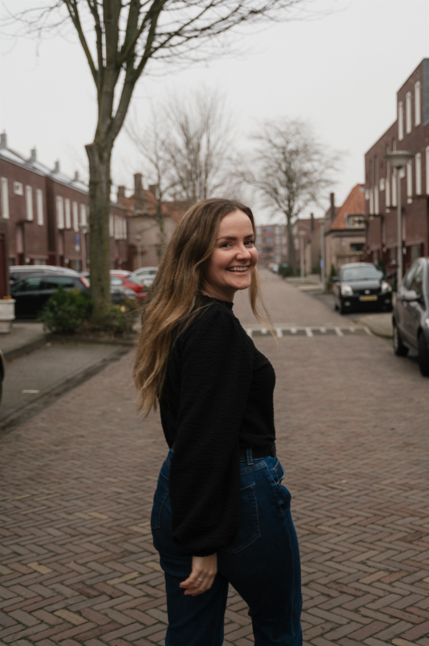 Amber smiling on a quiet residential street in Eindhoven.