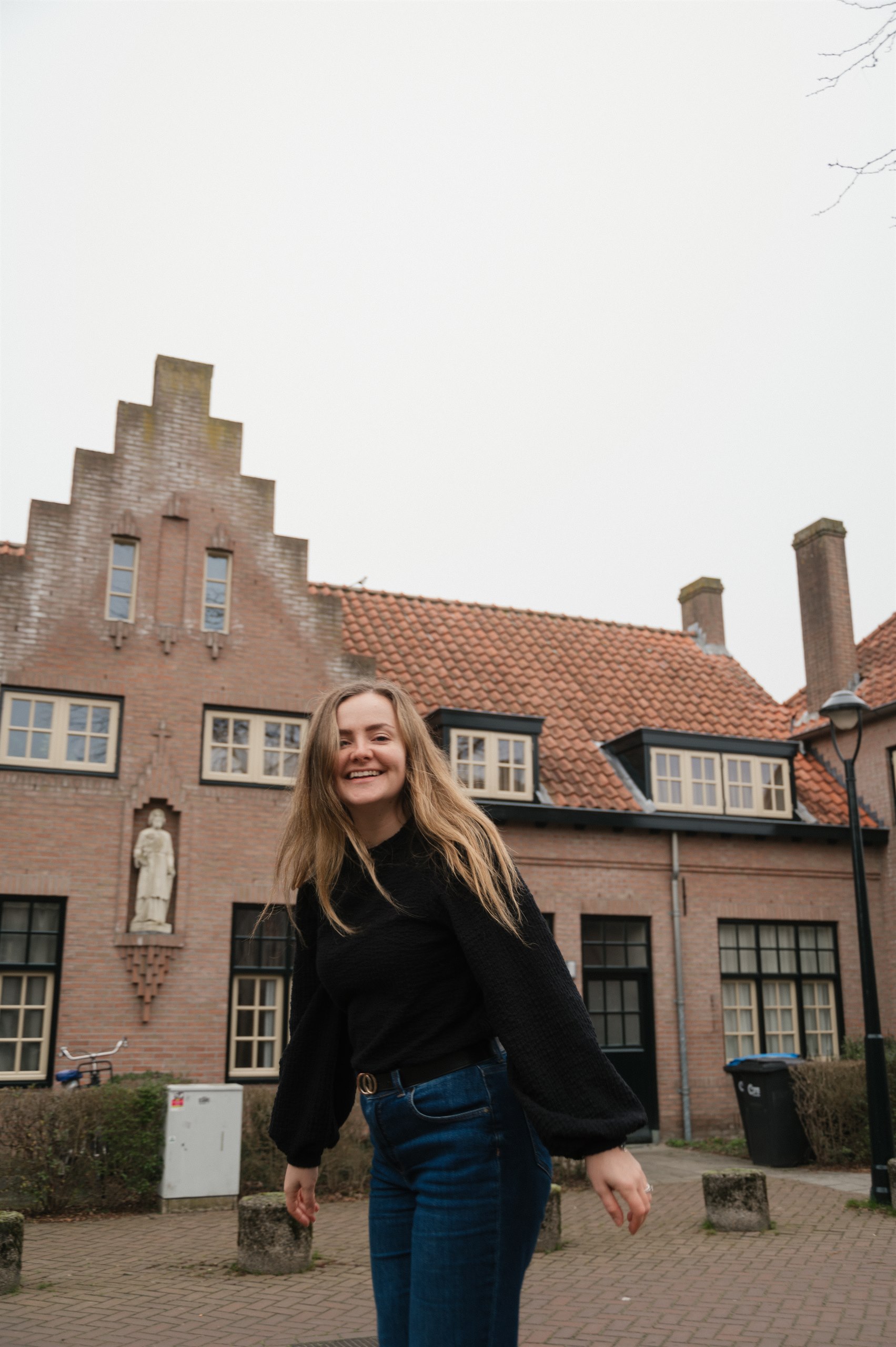 Amber smiling in a cobbled courtyard in Eindhoven.