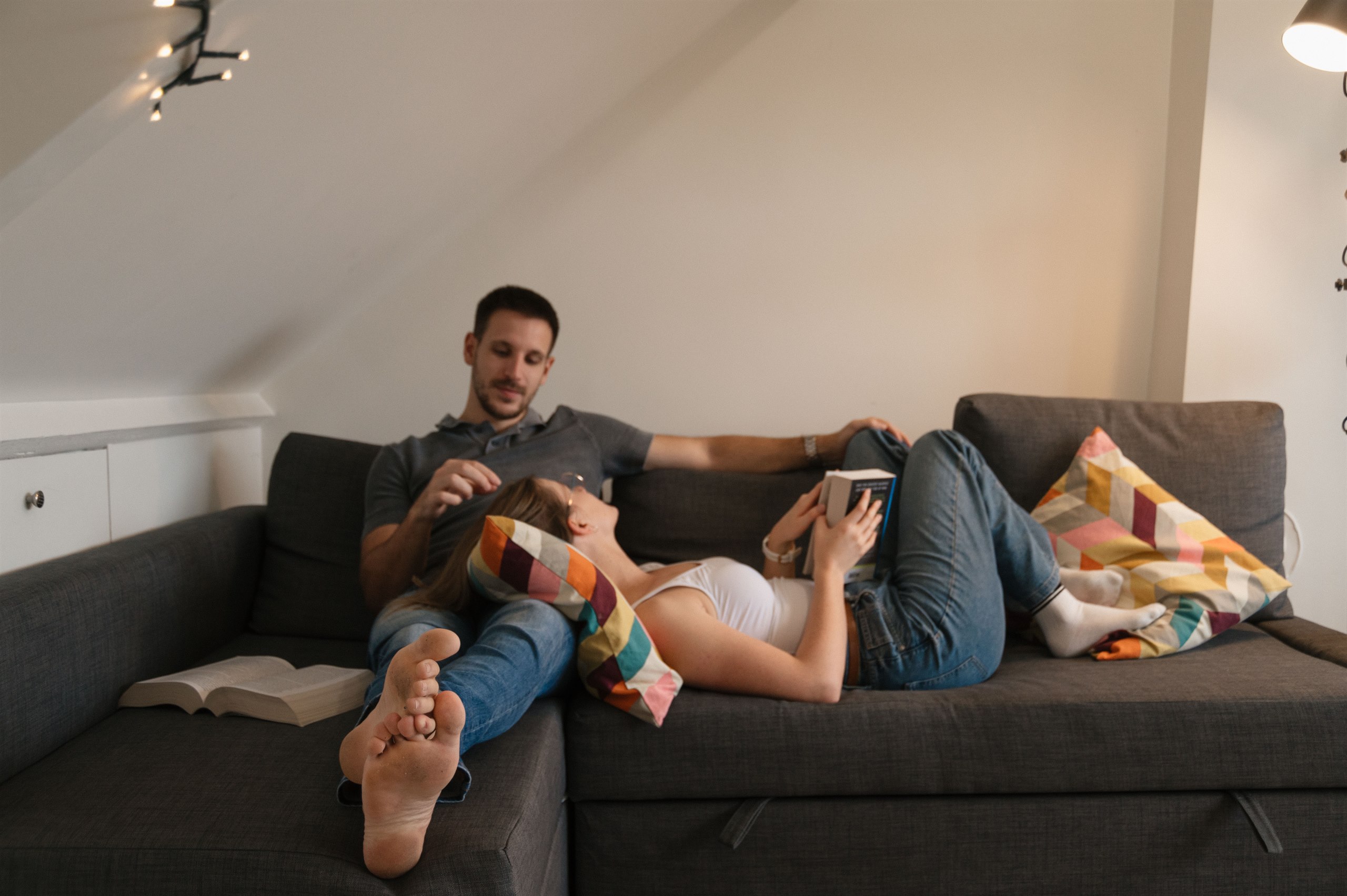 Couple relaxing together on a sofa at home.