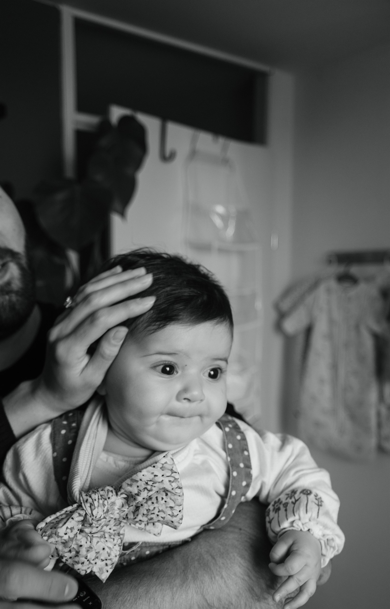 Black-and-white portrait of a baby looking toward the camera.