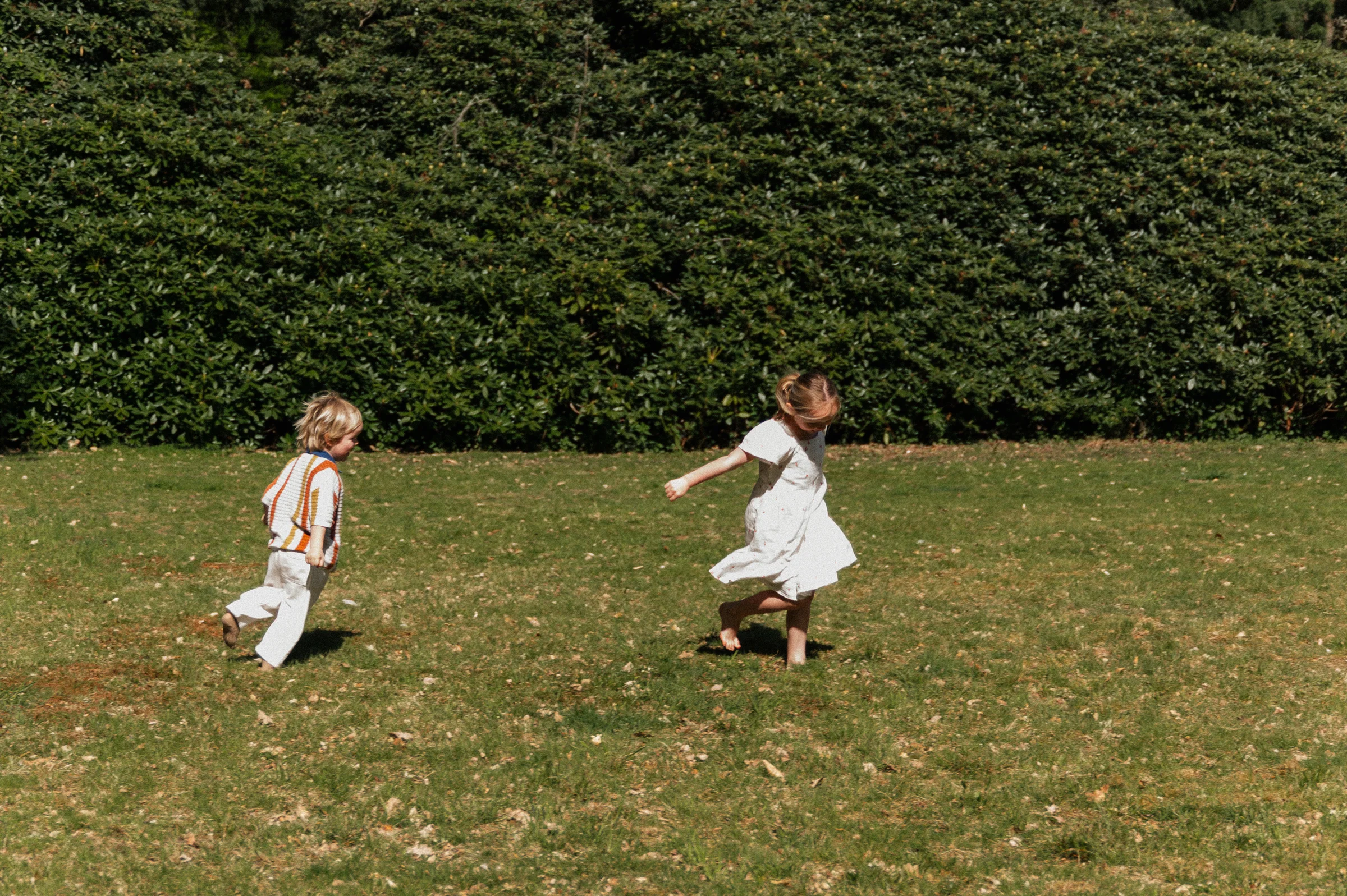 Kids running on grass in park