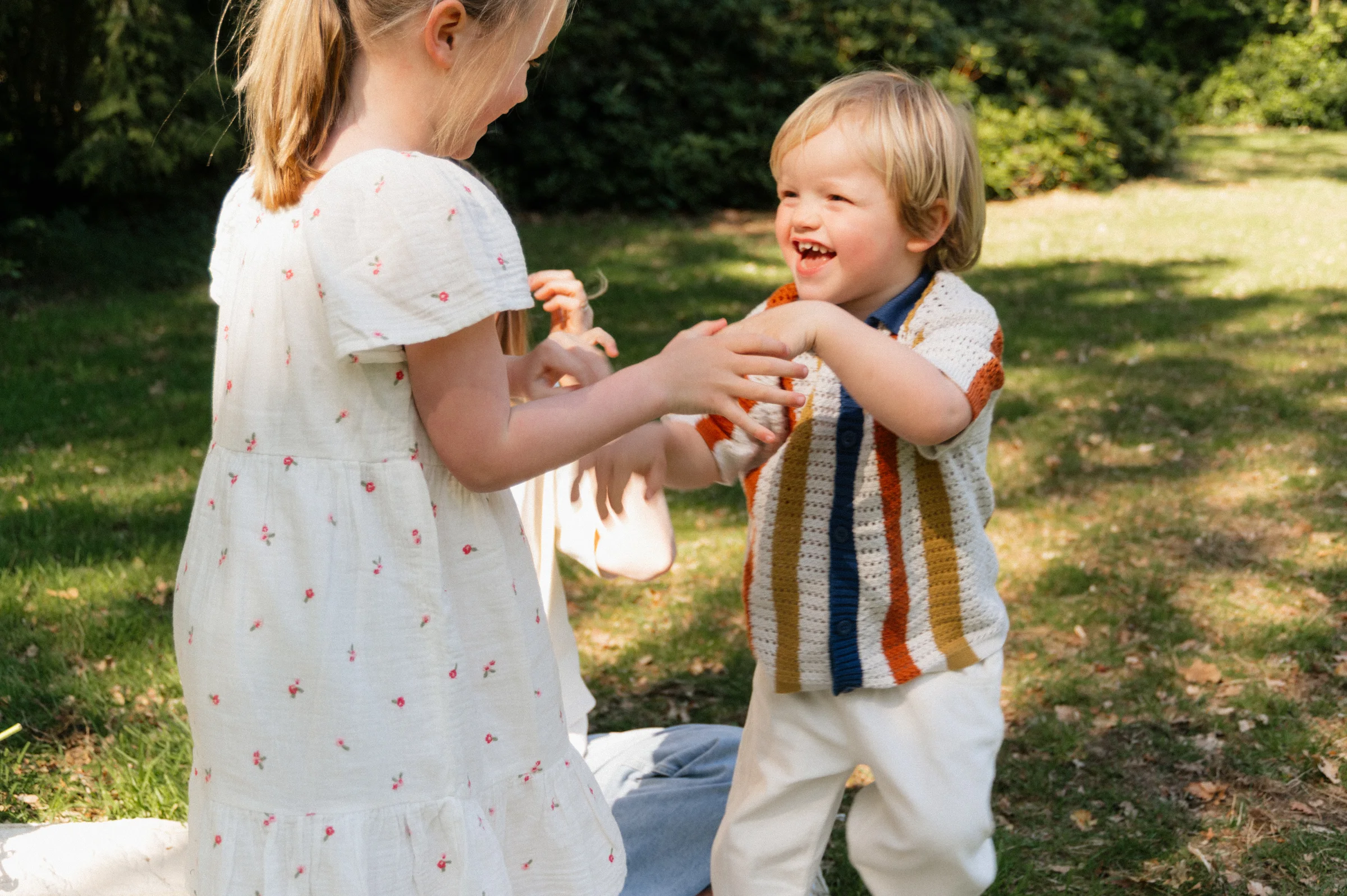 sister and brother playing tag almost catching one another