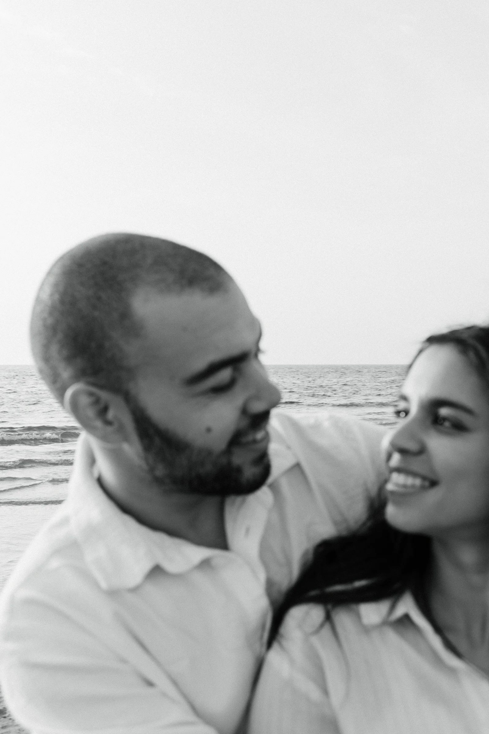 black and white photo of couple holding each other and looking at each other